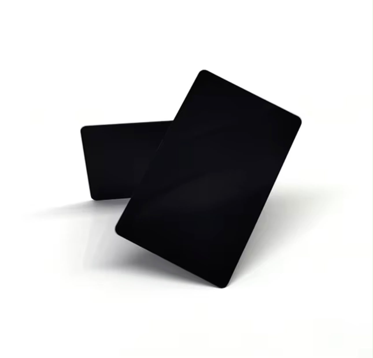 Two matte black Cardless NFC cards resting on a white surface